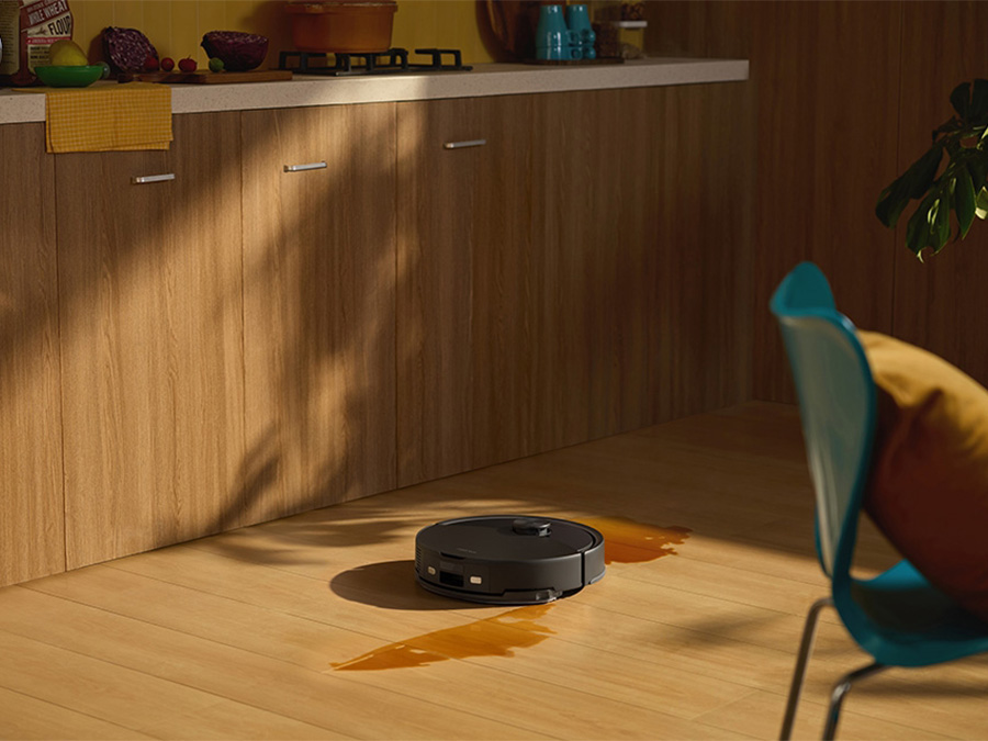 Roborock Q10 VF wischt verschüttete Flüssigkeit auf einem Holzboden in modernem Interieur